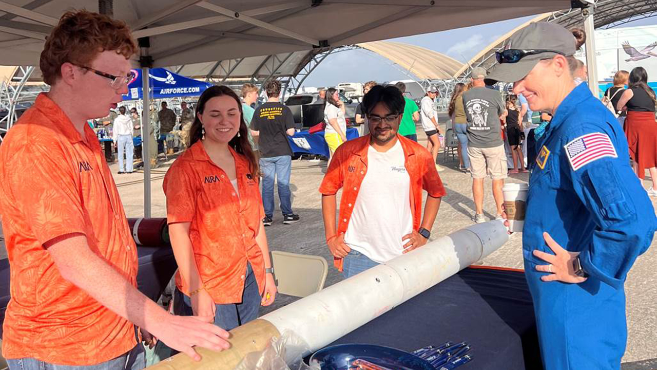 Members of the The Auburn University Rocketry Association (AURA) talk with NASA Astronaut Jessica Wittner at an airshow in Pensacola, Florida. 